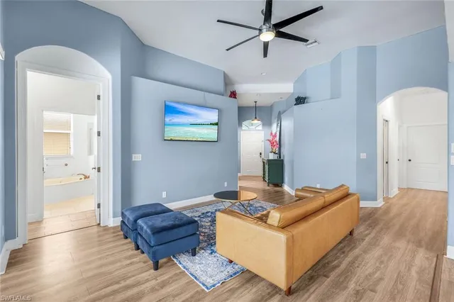 a living room with furniture and a wooden floor