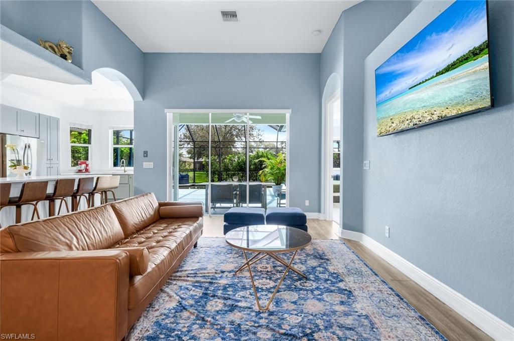 14846 Toscana Way Naples, FL 34120 - Photo 10 of 33 a living room with furniture and a rug