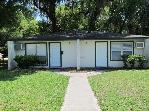 a front view of house with yard and trees