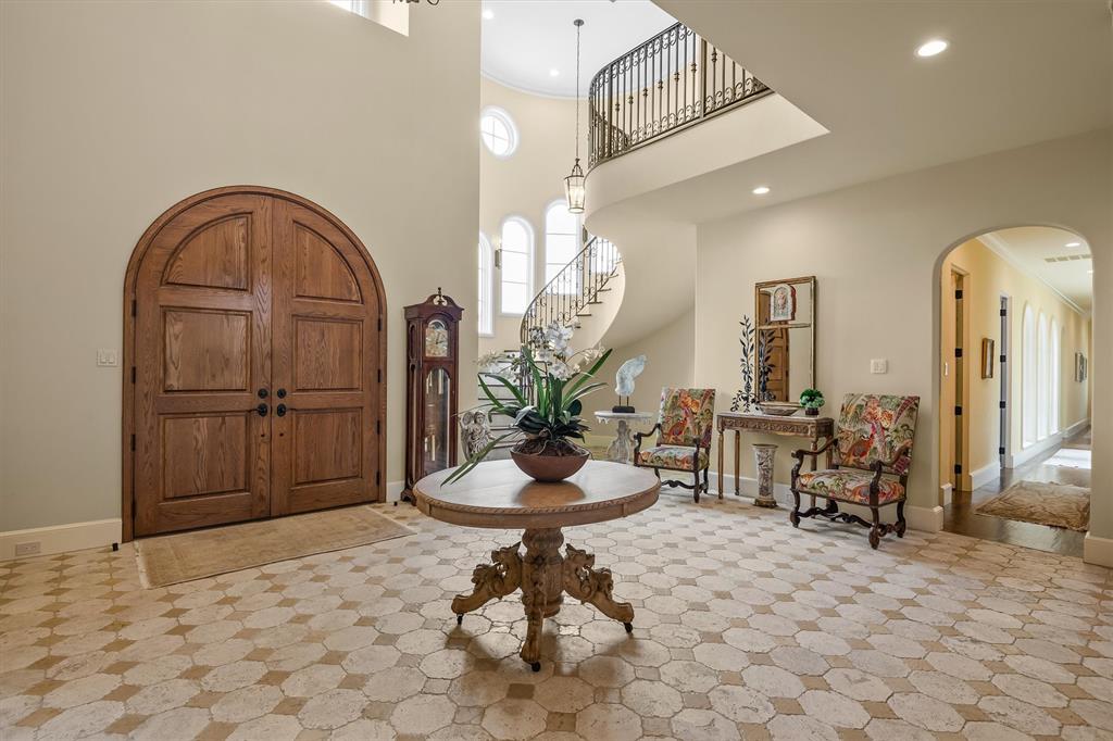 4101 Howard Road Waxahachie, TX 75165 - Photo 11 of 40 The dramatic entry welcomes your guests with a two story ceiling, and a curved stairwell ensconced in the castle's turret.