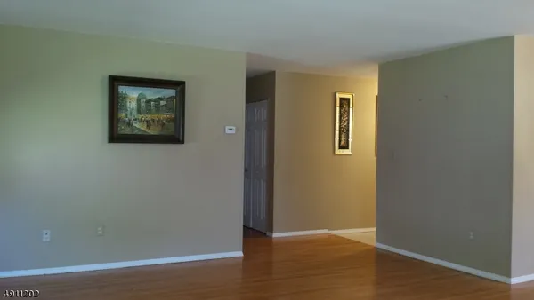 an empty room with wooden floor and closet