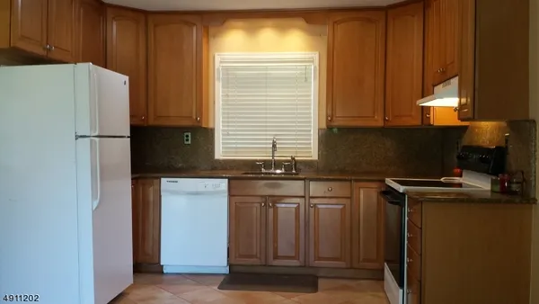 a kitchen with a refrigerator and a sink
