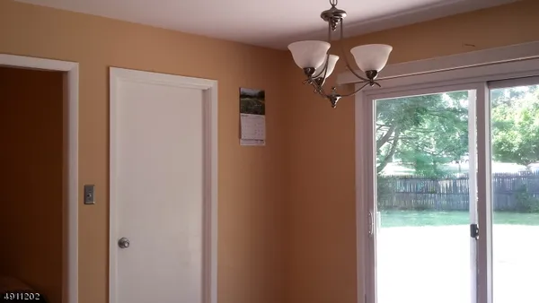 a view of a hallway with a chandelier