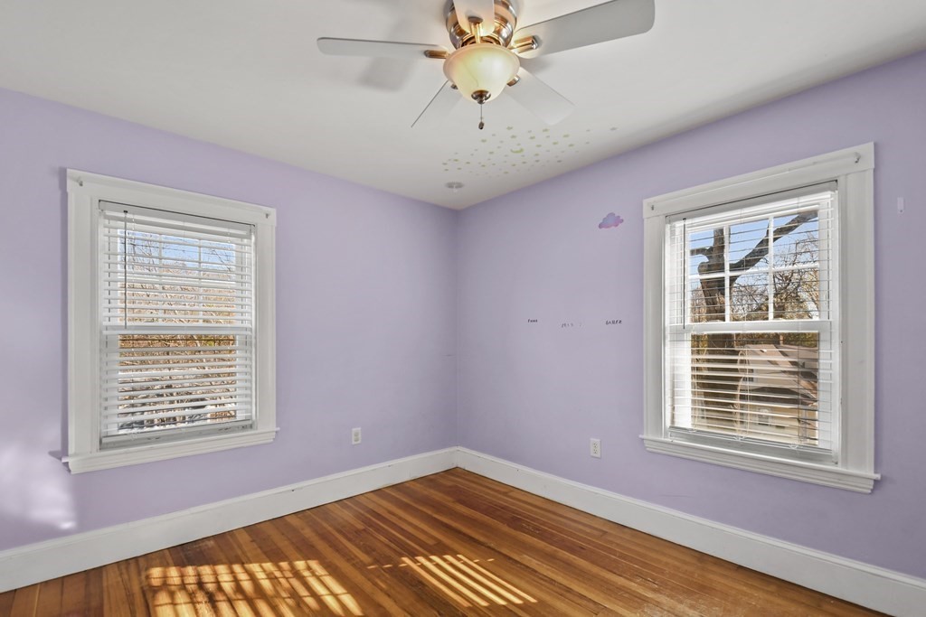 54 Thomas Street Dedham, MA 02026 - Photo 11 of 17 a view of an empty room with a window and wooden floor