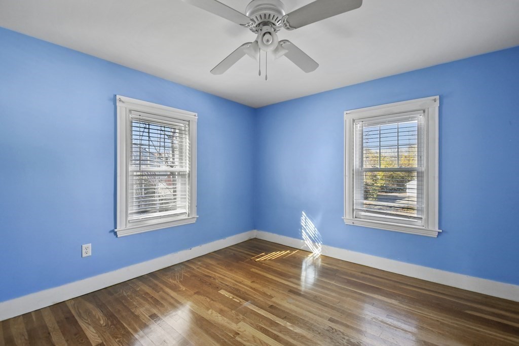 54 Thomas Street Dedham, MA 02026 - Photo 12 of 17 a view of empty room with wooden floor and fan