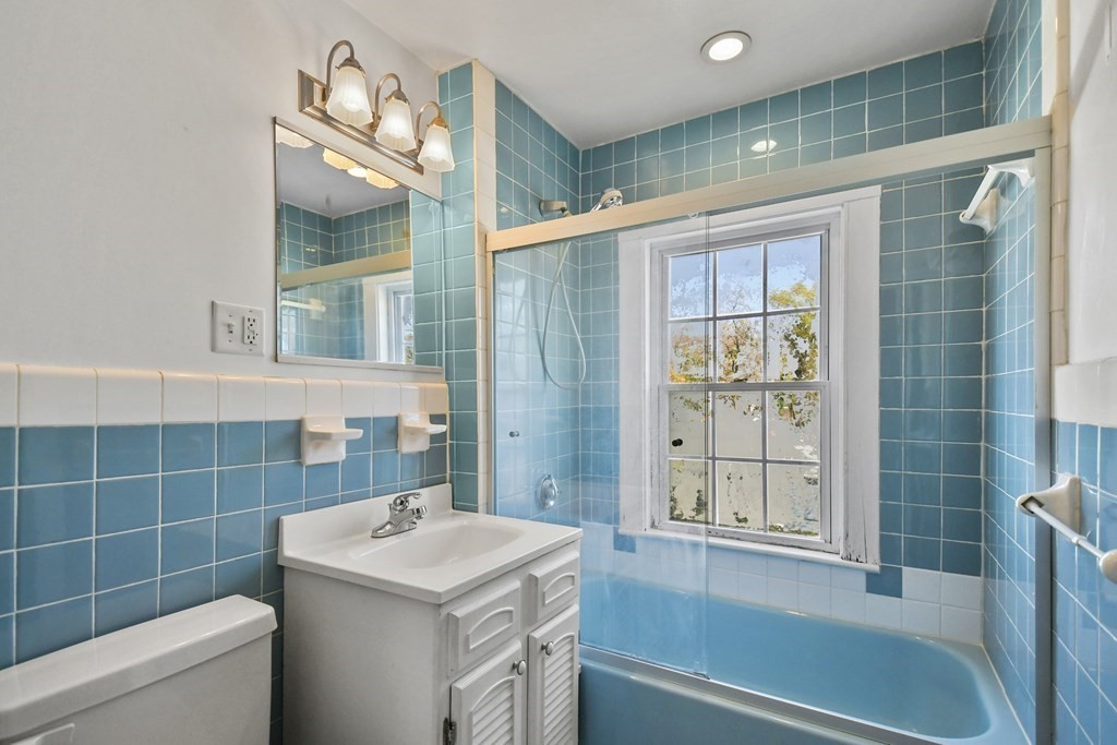 54 Thomas Street Dedham, MA 02026 - Photo 13 of 17 a bathroom with a sink toilet vanity and shower