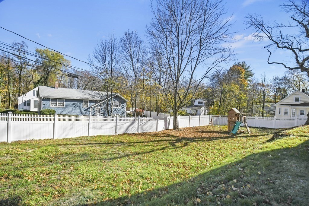 54 Thomas Street Dedham, MA 02026 - Photo 2 of 17 a swimming pool with outdoor seating and yard