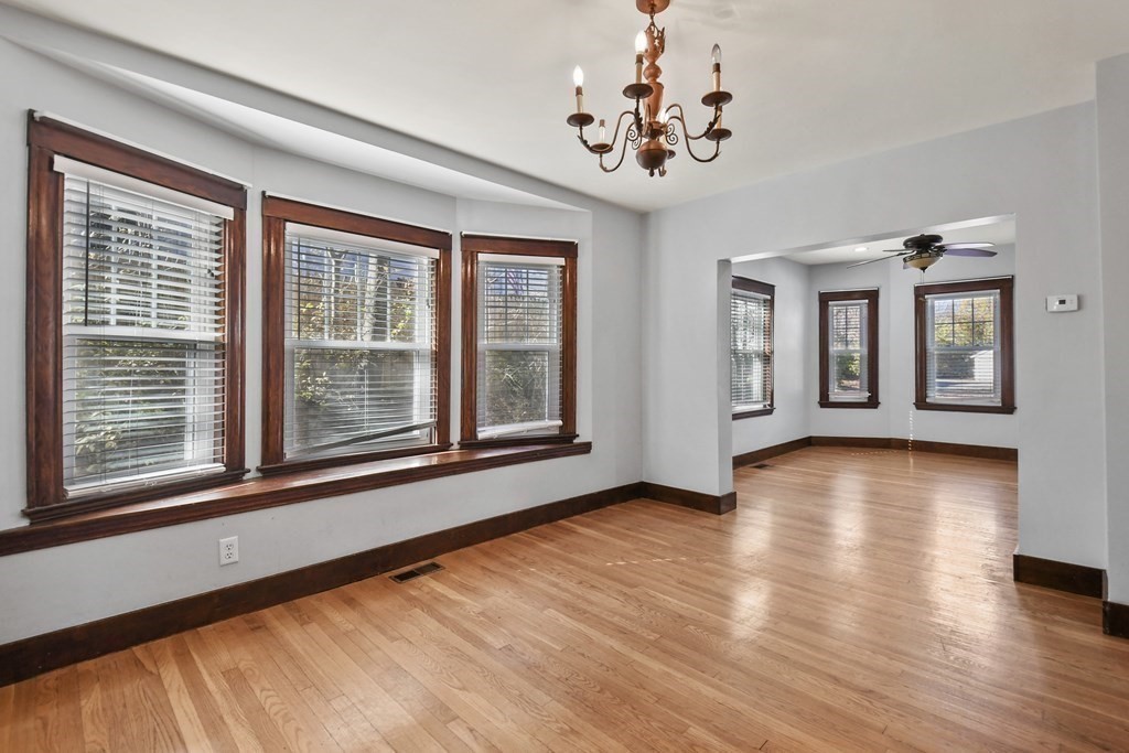 54 Thomas Street Dedham, MA 02026 - Photo 6 of 17 a view of an room with wooden floor and windows