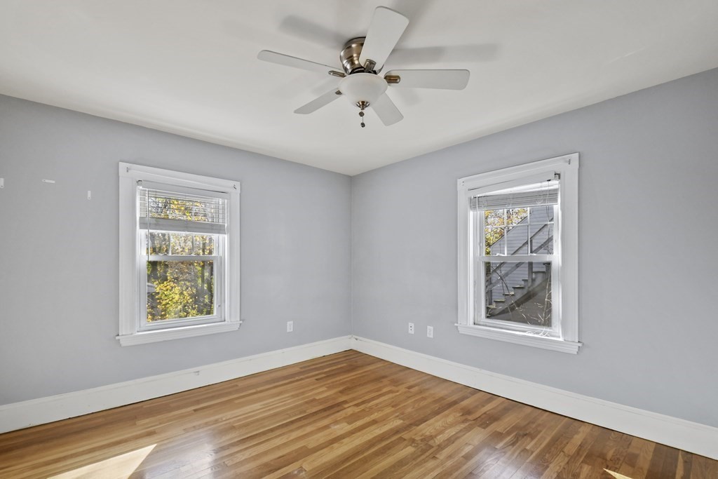 54 Thomas Street Dedham, MA 02026 - Photo 10 of 17 a view of an empty room with window and wooden floor