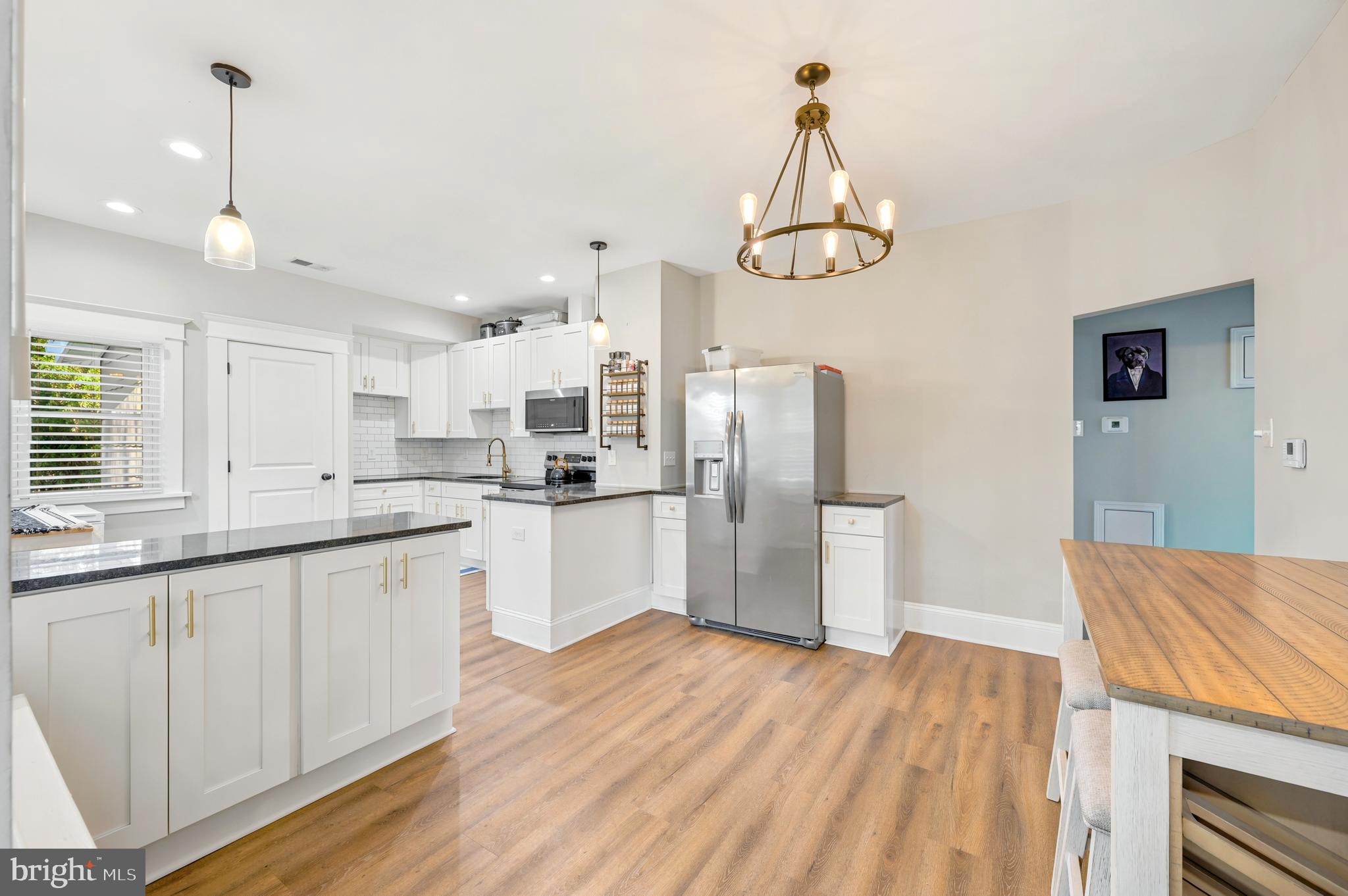 211 North Sylvania Avenue Jenkintown, PA 19046 - Photo 5 of 17 a kitchen with stainless steel appliances granite countertop a refrigerator a sink dishwasher a stove and white countertops with wooden floor
