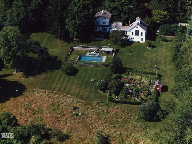 an aerial view of a house with a yard basket ball court and outdoor seating