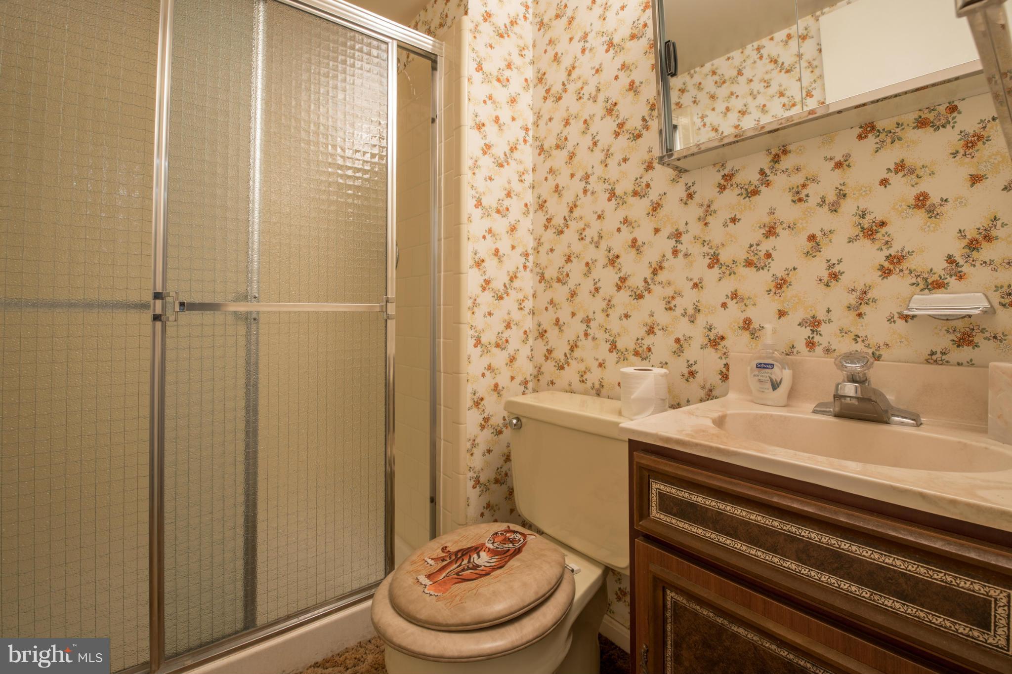 9215 Setter Place Springfield, VA 22153 - Photo 21 of 23 a bathroom with a granite countertop toilet and a sink
