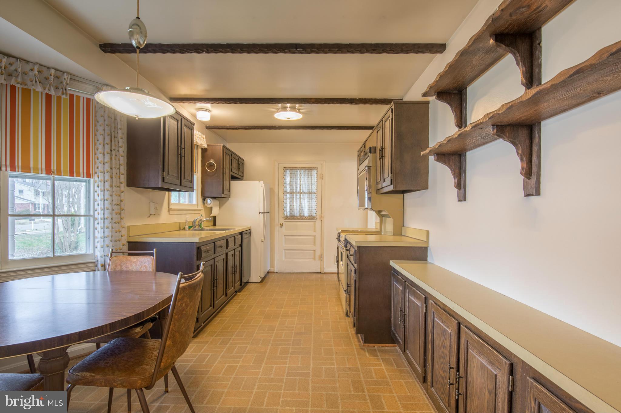 9215 Setter Place Springfield, VA 22153 - Photo 7 of 23 a kitchen with a table chairs sink and cabinets