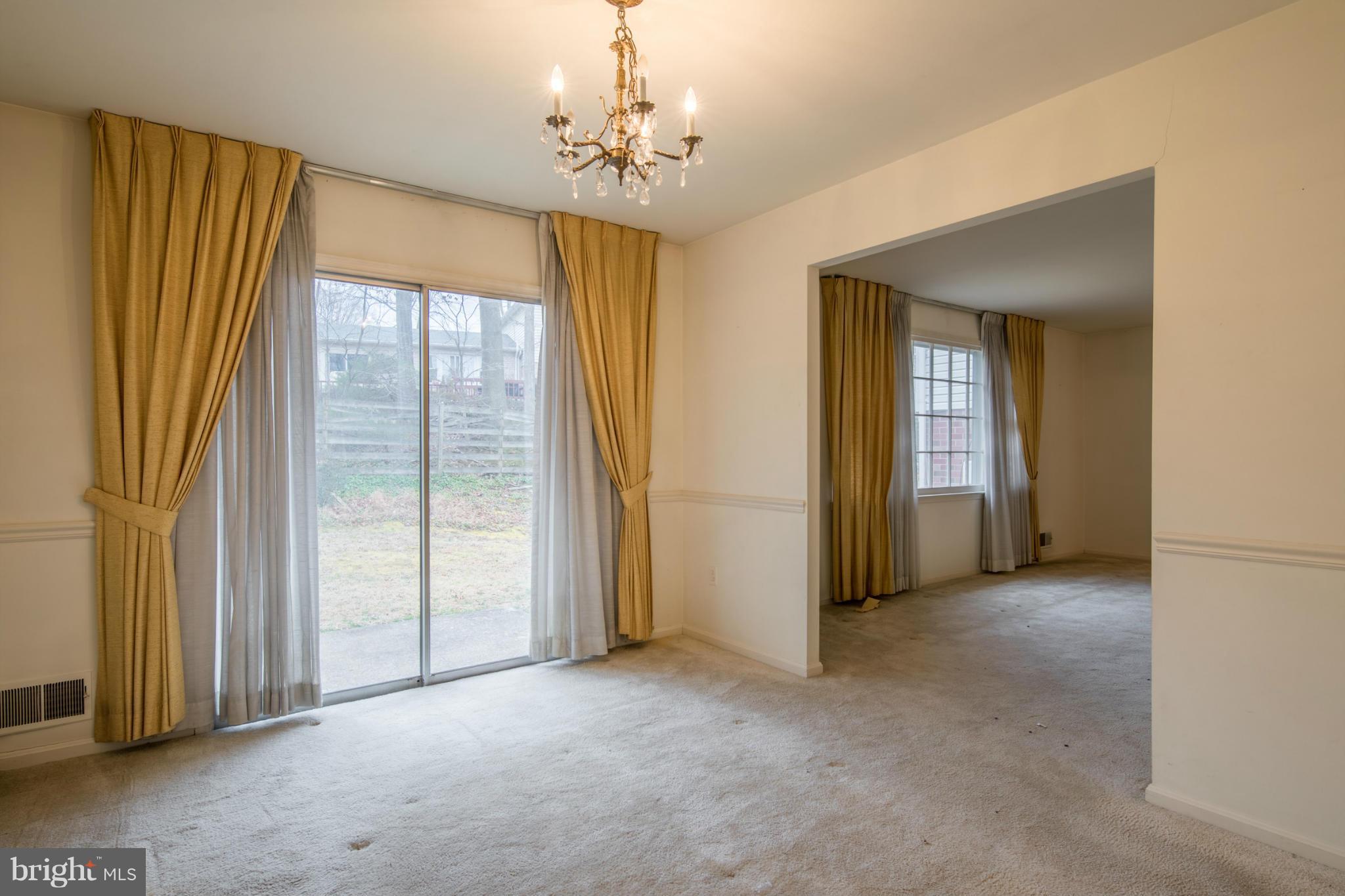 9215 Setter Place Springfield, VA 22153 - Photo 10 of 23 a view of a spacious bedroom with windows and chandelier