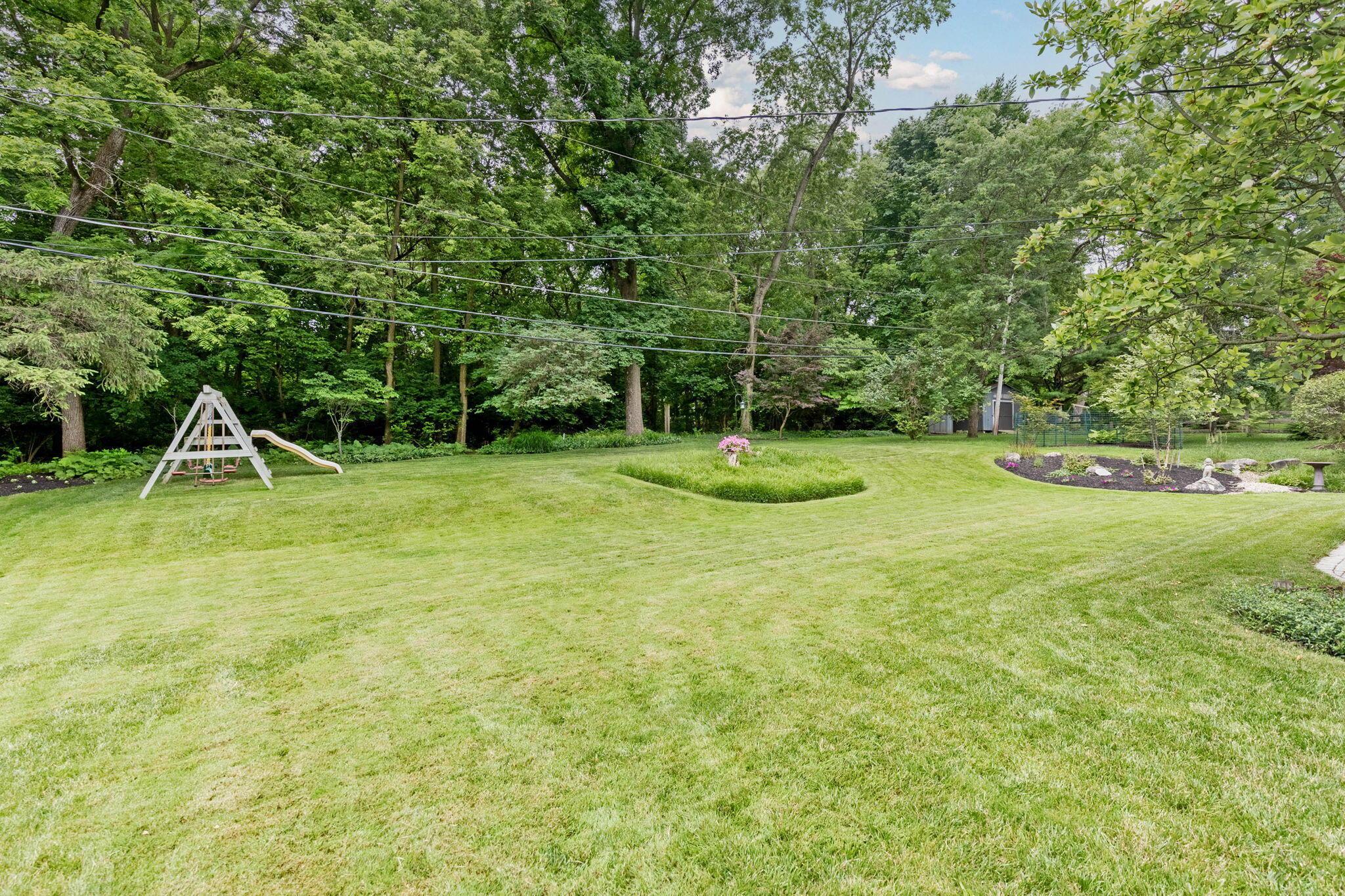 999 Birchmont Road Columbus, OH 43220 - Photo 35 of 53 Backyard is sloped and abuts a wooded forest with paths to St. Timothy School.