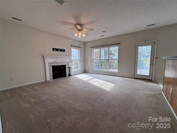 a view of empty room with a fireplace