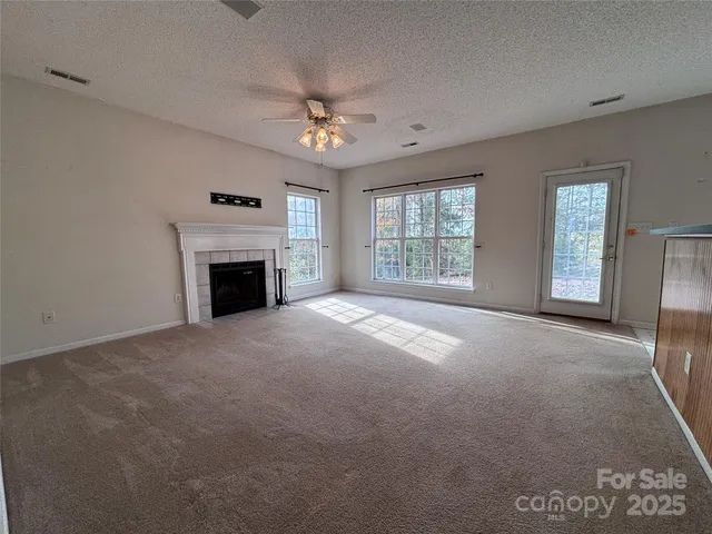 a view of empty room with a fireplace