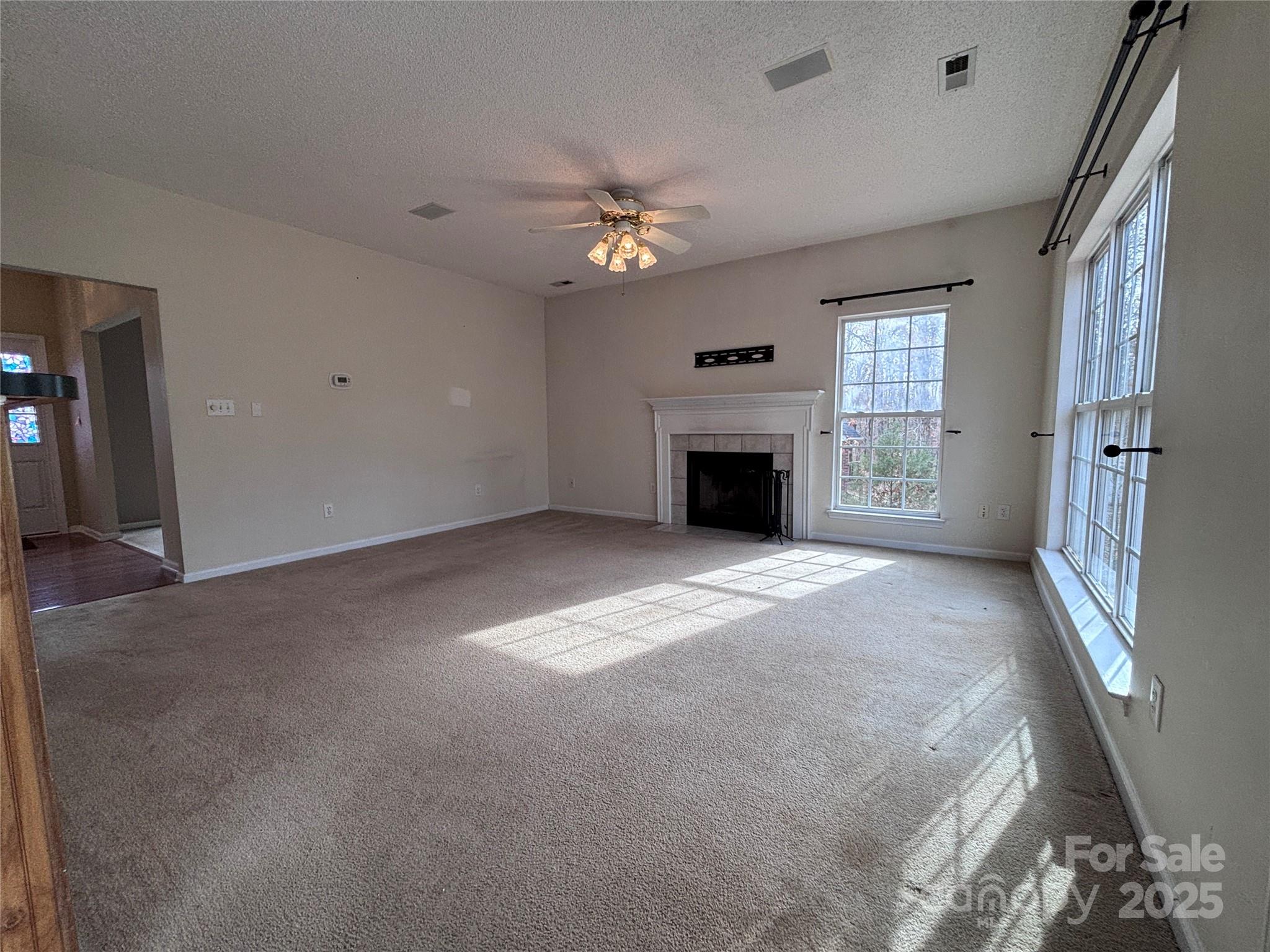 1600 Trotters Ridge Road Stanfield, NC 28163 - Photo 14 of 32 a view of an empty room with a fireplace and a window