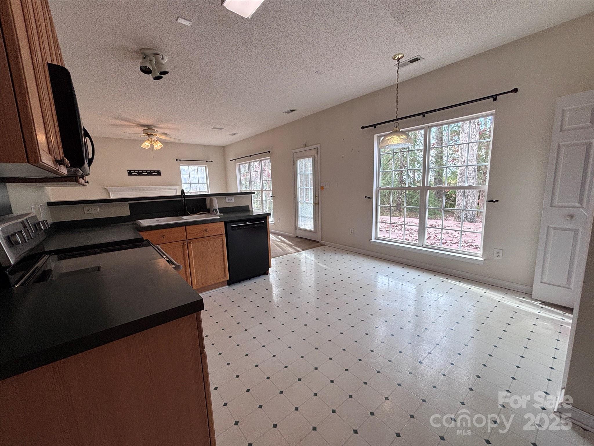 1600 Trotters Ridge Road Stanfield, NC 28163 - Photo 17 of 32 a kitchen with stainless steel appliances granite countertop a stove a sink and a refrigerator