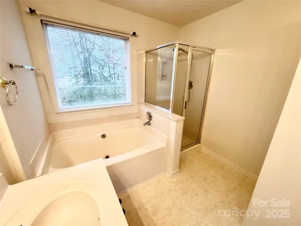 a bathroom with a bathtub and shower