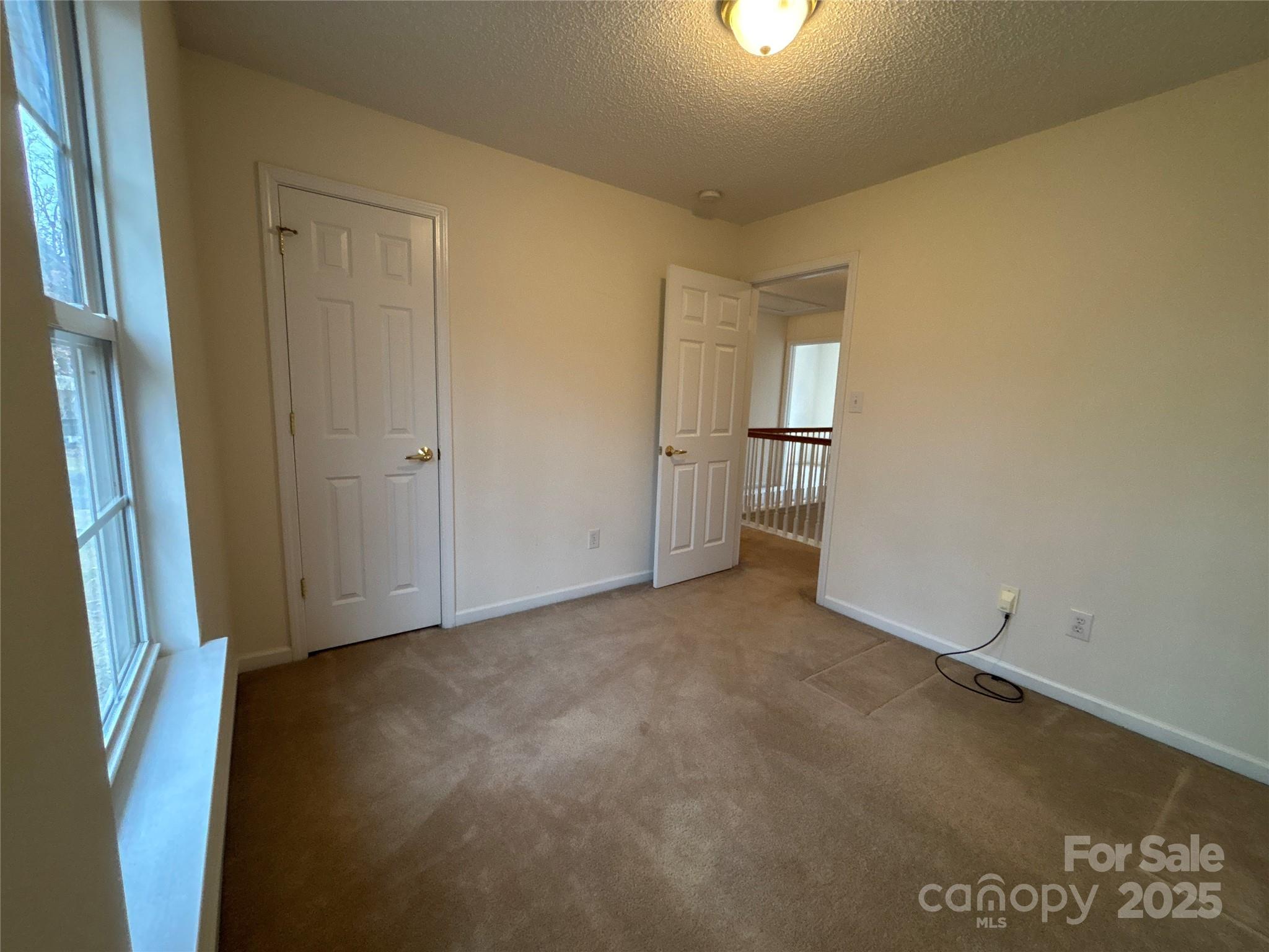 1600 Trotters Ridge Road Stanfield, NC 28163 - Photo 30 of 32 an empty room with windows