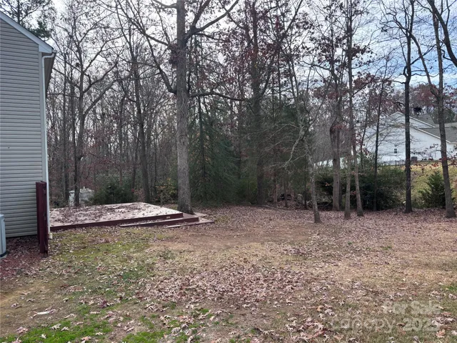 a view of a backyard with trees
