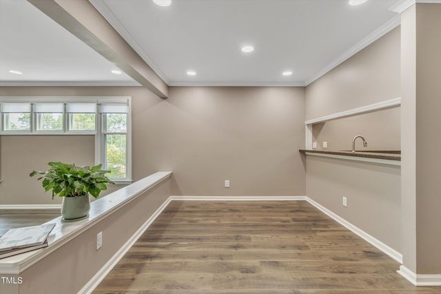 a kitchen with granite countertop white cabinets and a sink