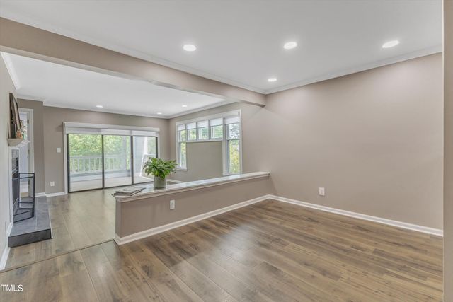 a kitchen with stainless steel appliances granite countertop a refrigerator stove and white cabinets