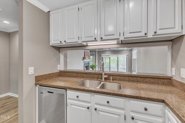 a kitchen with cabinets and stainless steel appliances