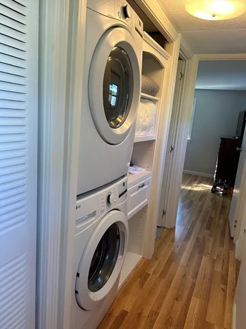 a view of a hallway with washer and dryer