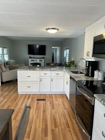 a kitchen with stainless steel appliances a stove a sink and a microwave