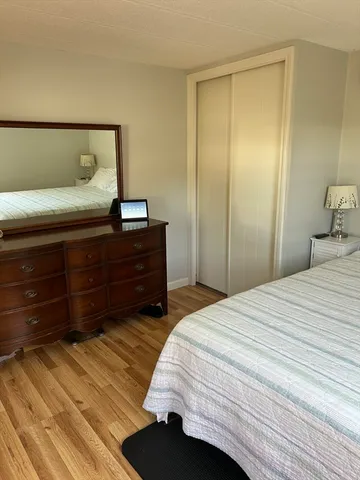 a bedroom with a bed and a dresser