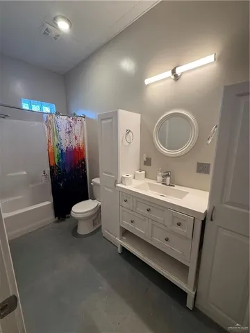 a bathroom with a toilet sink double vanity and mirror