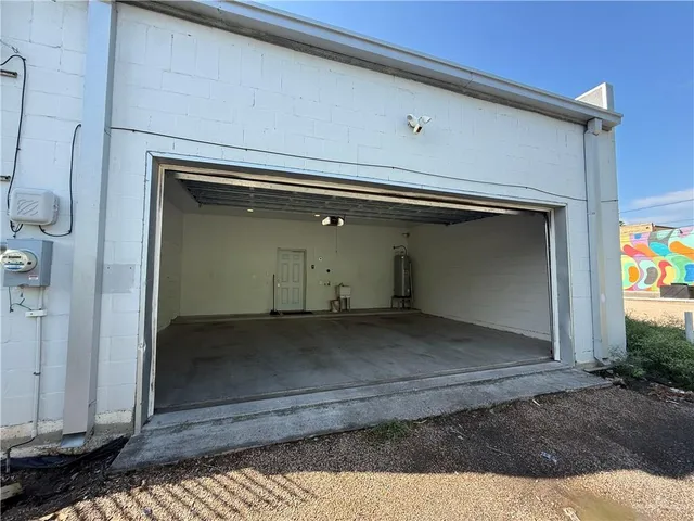 a view of a kitchen with stainless steel appliances wooden floor and a refrigerator