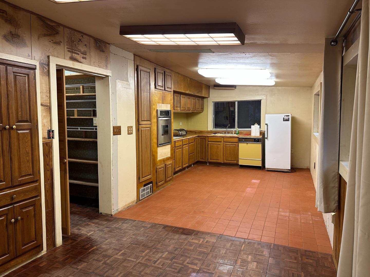 121 La Honda Road Woodside, CA 94062 - Photo 5 of 22 a kitchen with refrigerator and cabinets