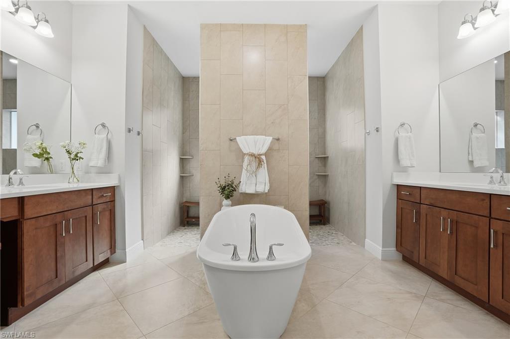 3707 5th Avenue Southwest Naples, FL 34117 - Photo 18 of 45 Full bath featuring walk in shower, a soaking tub, and two vanities