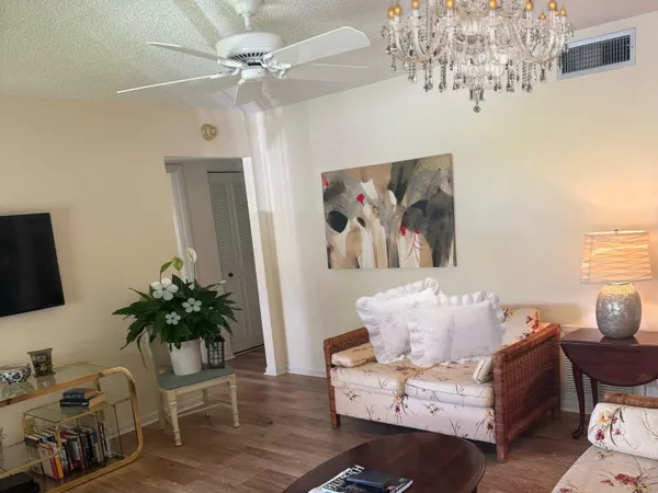 a living room with furniture and a potted plant