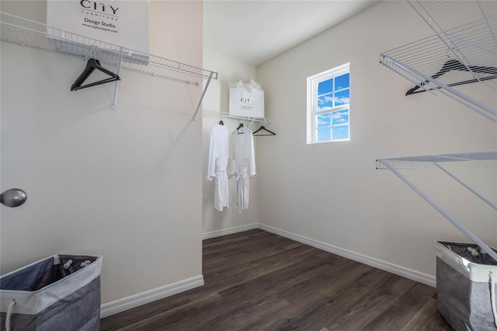 3415 Nettle Loop Tavares, FL 32778 - Photo 22 of 28 a view of a room with wooden floor and a ceiling fan