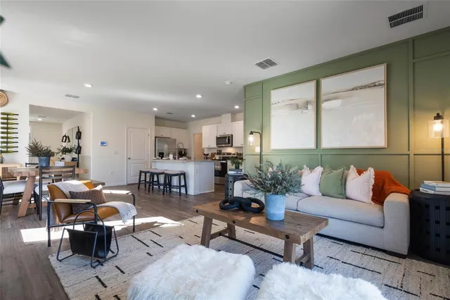 a living room with furniture kitchen view and a table