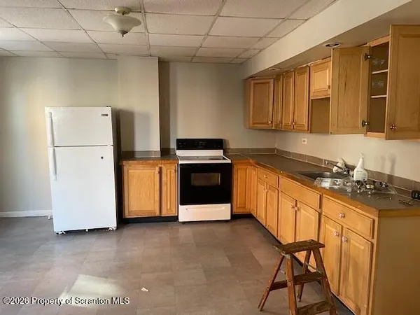 a kitchen with stainless steel appliances granite countertop a stove a sink dishwasher and a refrigerator
