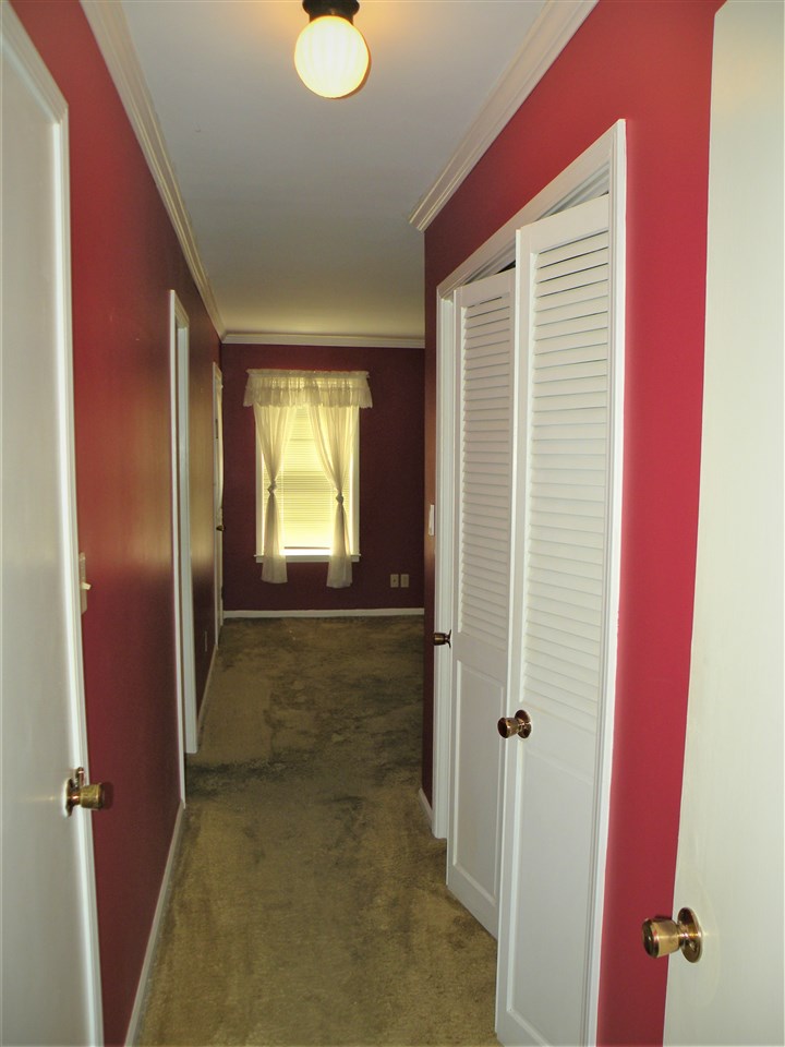 3041 Carnoustie Road Memphis, TN 38128 - Photo 15 of 25 This hall leads to the master bedroom. There is a walk-in closet on one side and a wall closet on the other.