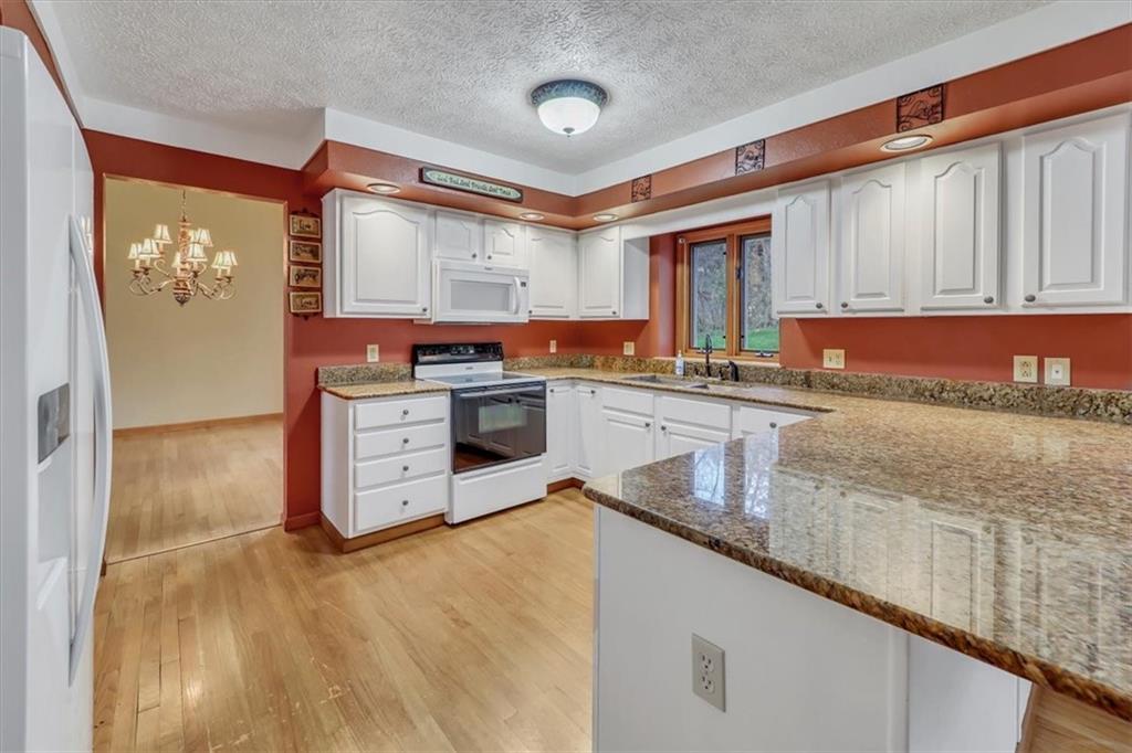 351 Cobblestone Circle McKees Rocks, PA 15136 - Photo 6 of 23 a kitchen with stainless steel appliances granite countertop a stove a sink and a microwave