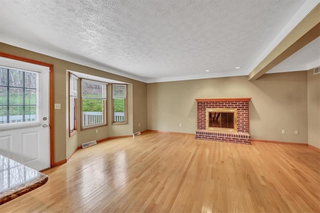 351 Cobblestone Circle McKees Rocks, PA 15136 - Photo 7 of 23 a view of an empty room with wooden floor and a window