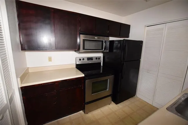 a kitchen with a refrigerator and a stove