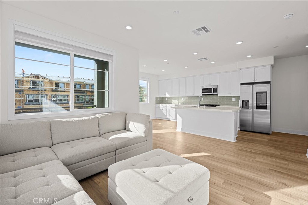 1713 Jade Road Rancho Mission Viejo, CA 92694 - Photo 13 of 53 a living room with furniture and kitchen view with wooden floor