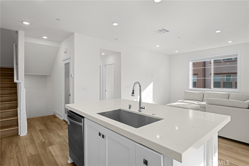 1713 Jade Road Rancho Mission Viejo, CA 92694 - Photo 19 of 53 a kitchen with stainless steel appliances granite countertop a sink and a large window