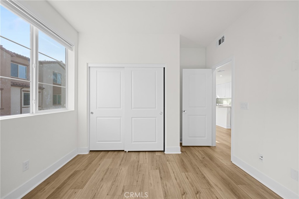 1713 Jade Road Rancho Mission Viejo, CA 92694 - Photo 32 of 53 a view of an empty room with wooden floor and a window
