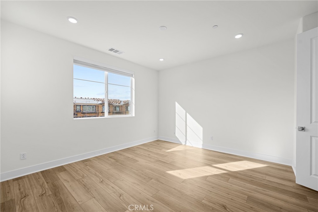 1713 Jade Road Rancho Mission Viejo, CA 92694 - Photo 39 of 53 an empty room with wooden floor and windows