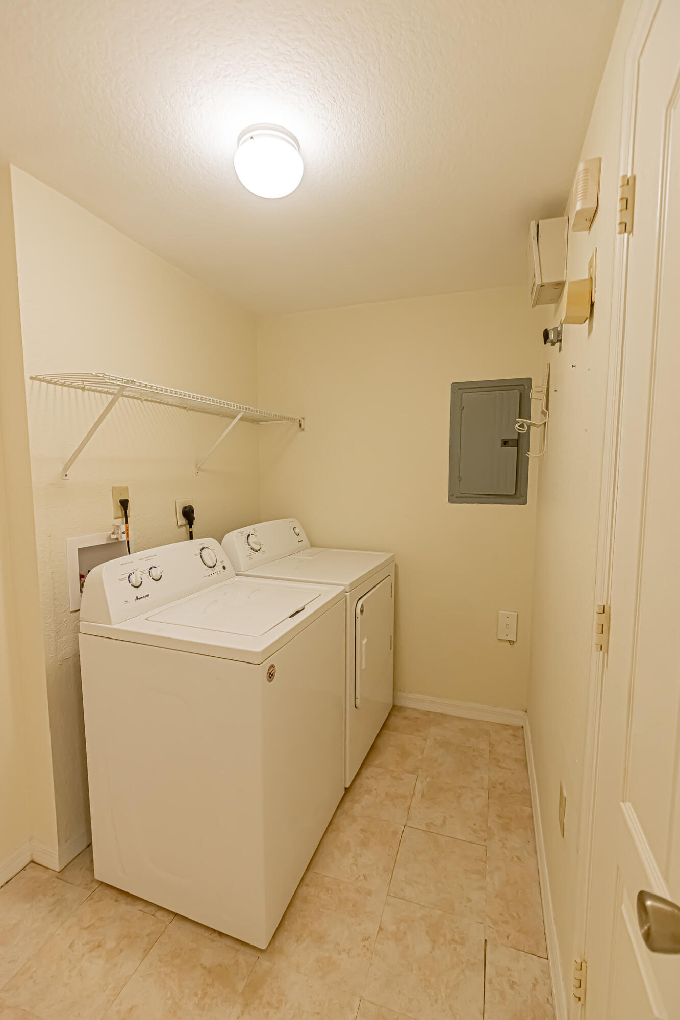 168 Southwest Peacock Boulevard, Unit 35103 Port St. Lucie, FL 34986 - Photo 20 of 43 a utility room with dryer and washer