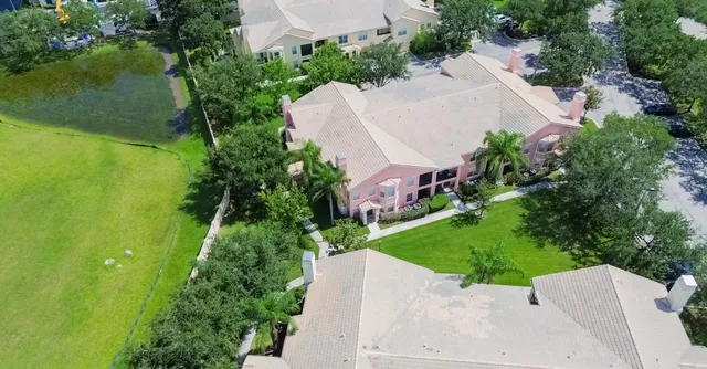 an aerial view of a house with a yard basket ball court and outdoor seating